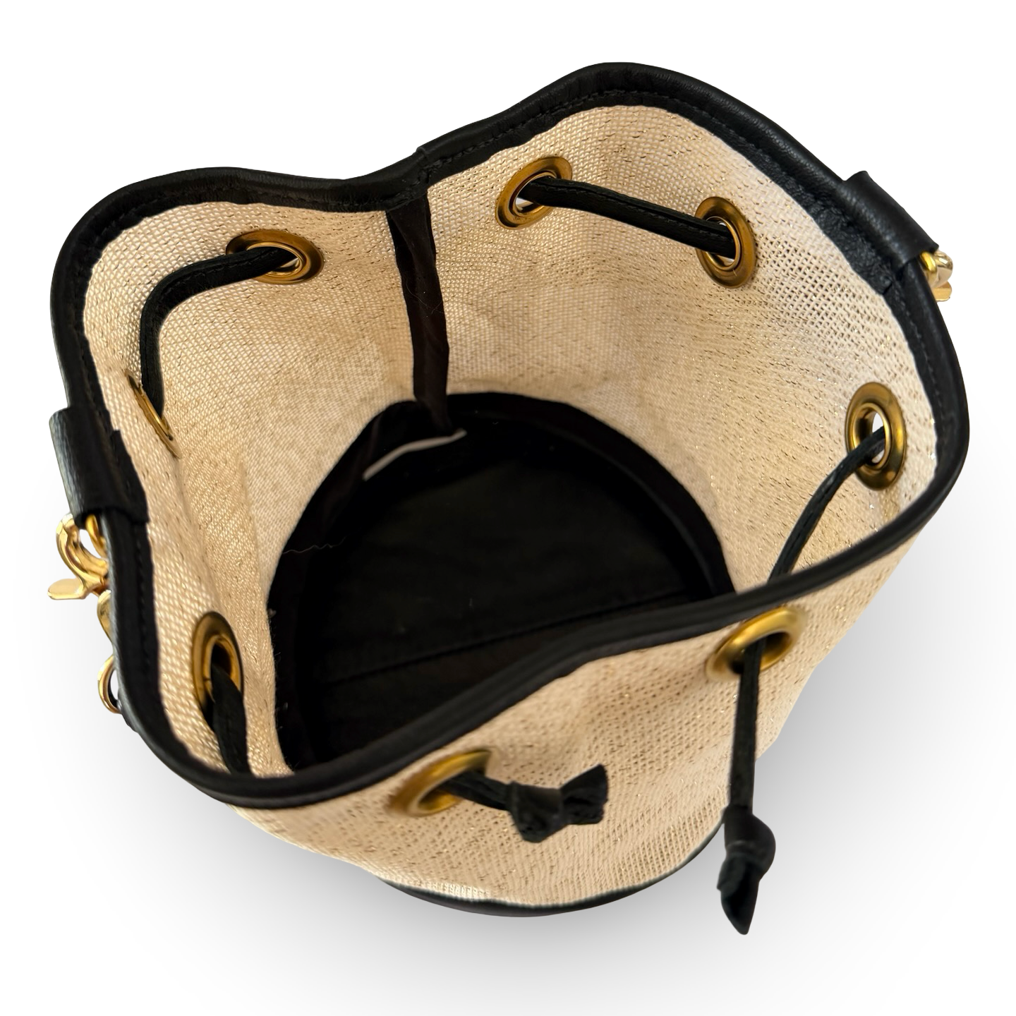 Beige bucket bag with black drawstring on a white background