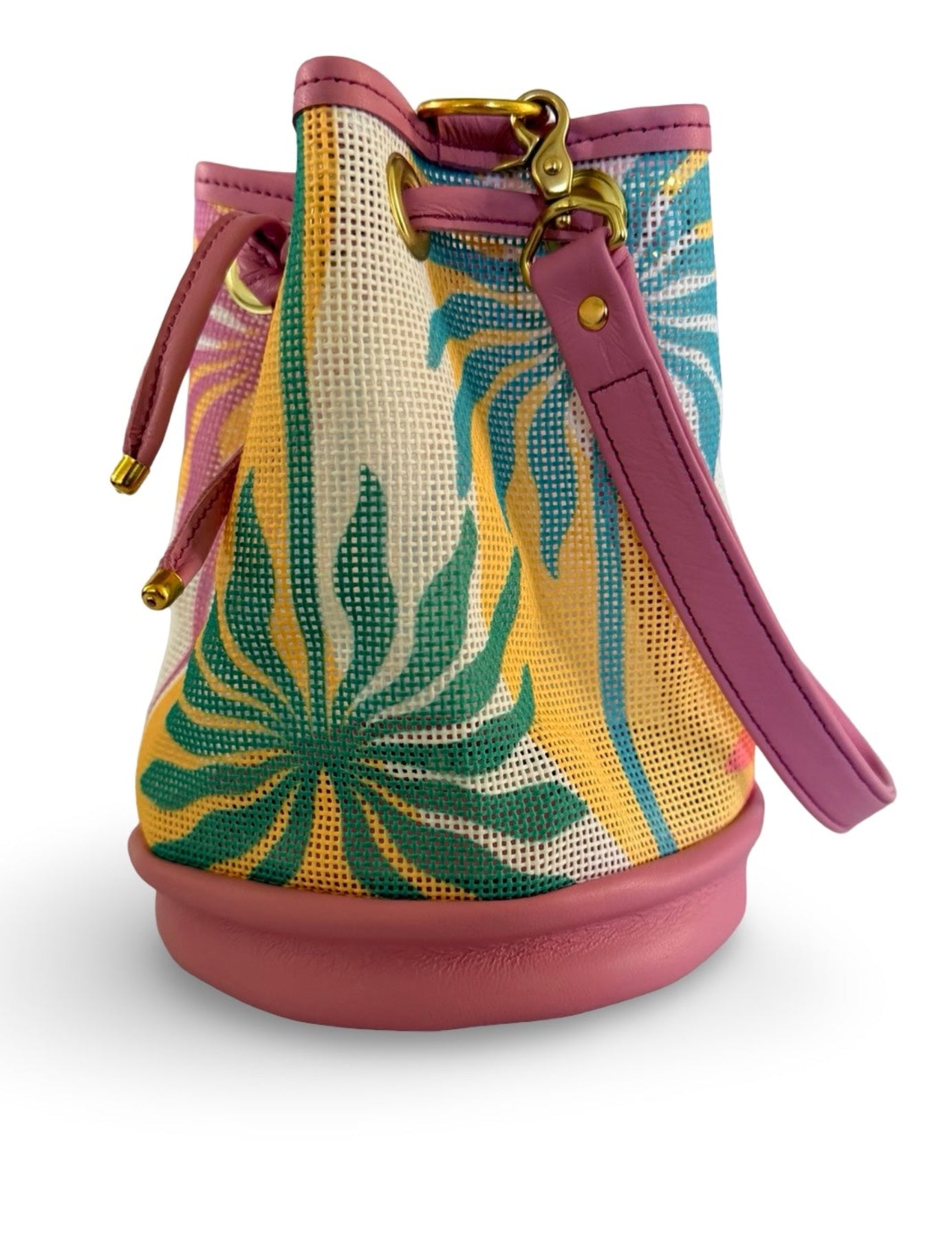 Bucket bag with tropical leaf pattern and pink accents on a white background